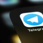 Imagem ilustrativa sobre a segurança no Telegram e uso de blockchain. A imagem mostra a tela de um celular, com destaque para o aplicativo do Telegram na tela.